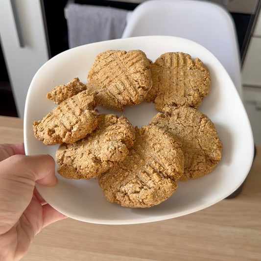 Dog-friendly peanut butter cookies on a white plate.